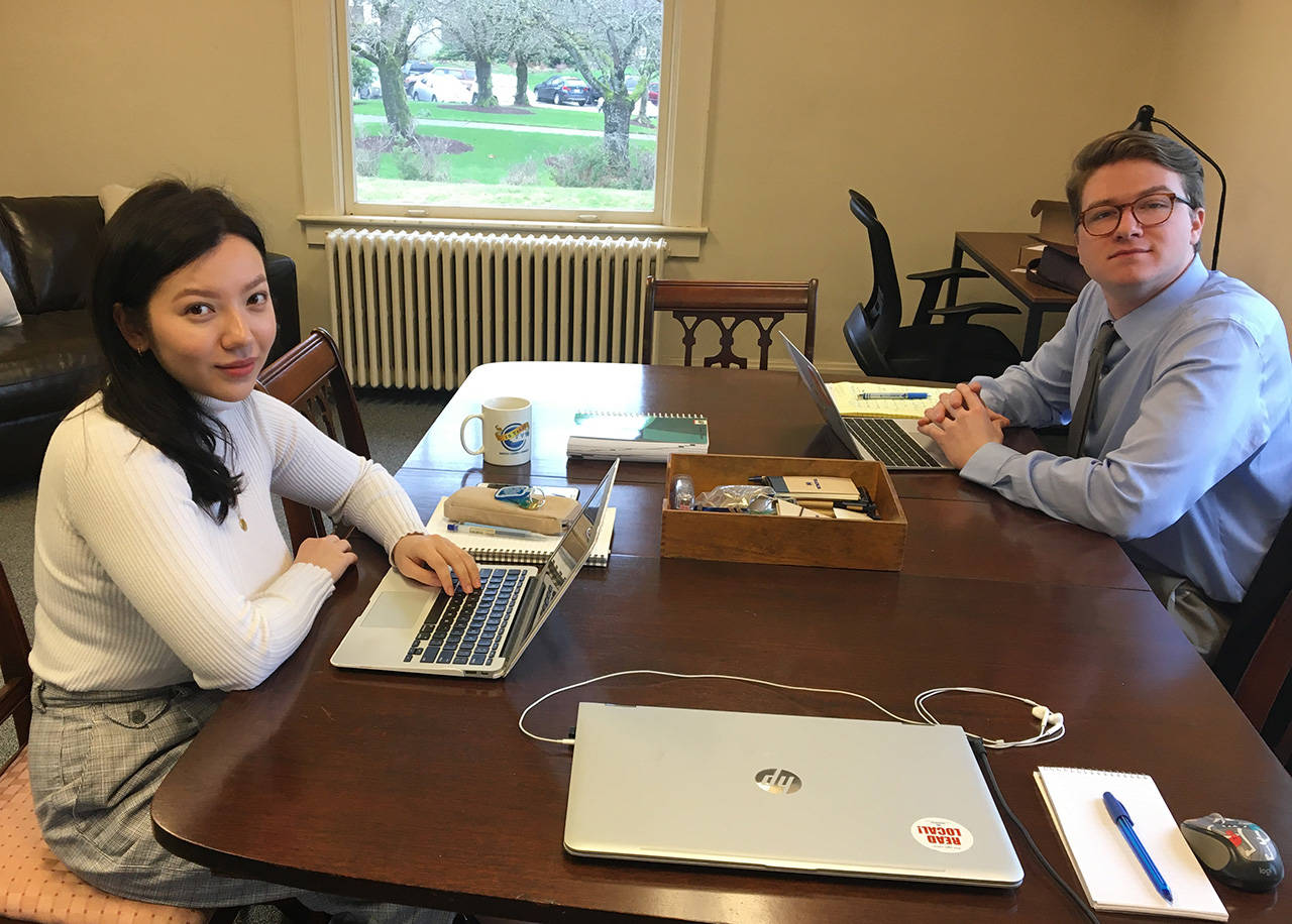 Reporters Leona Vaughn, left, and Cameron Sheppard, right, at work in the new office on the state Capitol campus. (Sandy Stokes photo)