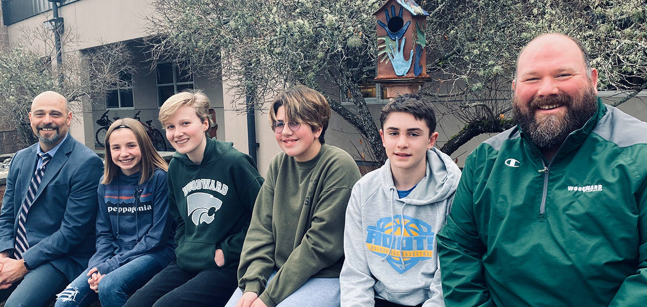 Woodward Middle School Principal Jeff Hale stands with Student of the Month winners Riley Becker, Clare Willmes, Abi Koon, and Luca Scheltens. At right is WMS Associate Principal Travis Tebo. (Photo courtesy of Woodward Middle School)