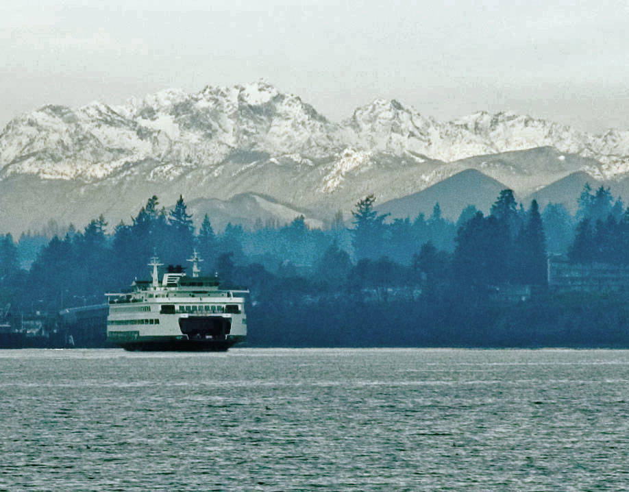 Bainbridge Island finally got its winter snow this week, but it only lasted a few days. Rebecca Barker said her family moved here two years ago from Canada and got a “little slice of home” with the snow as Michael, 6, built a snowman, complete with the COVID-19 safety mask of course. Meanwhile, Jim Beyea dug up this photo of the ferry in Bainbridge Island pulling out of the dock with the Olympics in the background. The National Weather Service issued a winter storm warning for the Bainbridge Island area Saturday. Last Thursday, city Operations Maintenance crews began working 12-hour shifts to provide 24-hour coverage. The city followed its Snow and Ice Control Plan that includes priority streets for response; crews focus first on main roads then neighborhood streets. The city is not operating the Severe Weather Shelter on Bainbridge Island this year due to COVID-19. But the Kitsap County Severe Weather Shelter in Poulsbo has been open at the Gateway Fellowship Church, 18901 8th Ave. Subscribe to shelter activation notifications by texting KITSAPSWS to 898-211. 
Courtesy photos