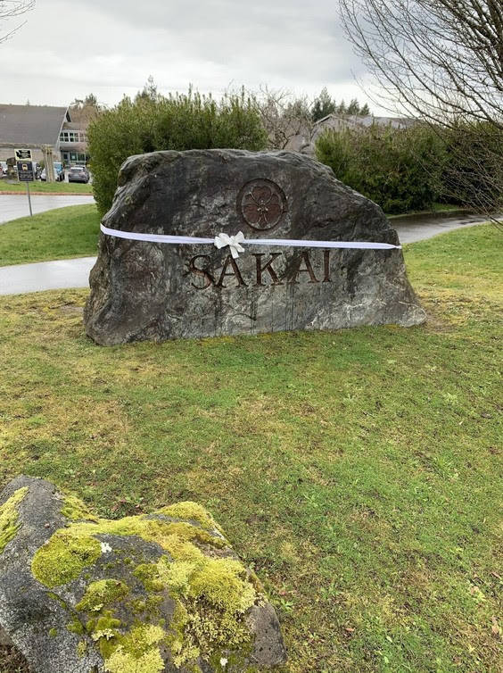 A white ribbon is wrapped around the Sakai rock in memory of its former students. Courtesy photo