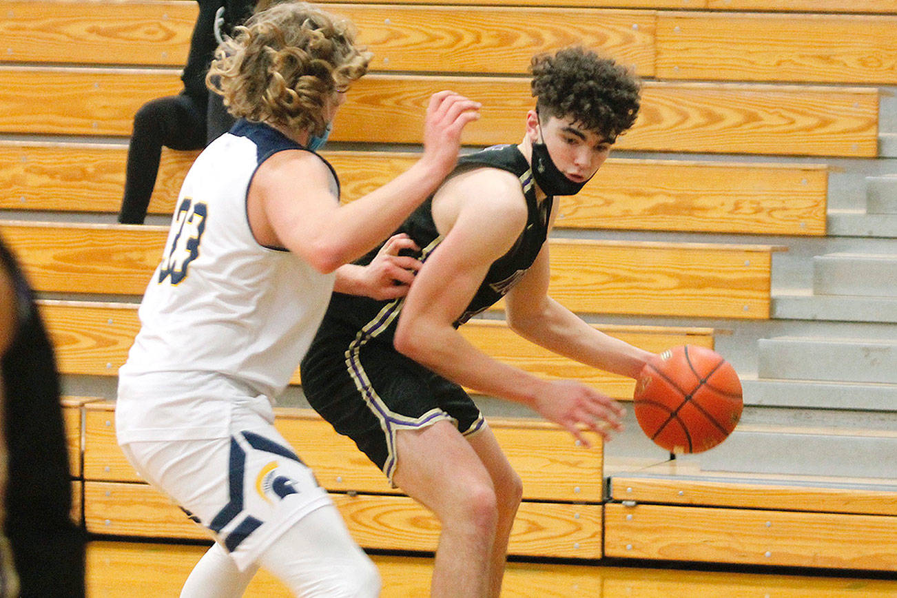 Jonas La Tour looks to get around Bainbridge’s Alan Ulin during Tuesday night’s game at Bainbridge High School. La Tour had 24 points as North Kitsap won 62-54. (Mark Krulish/Kitsap News Group)