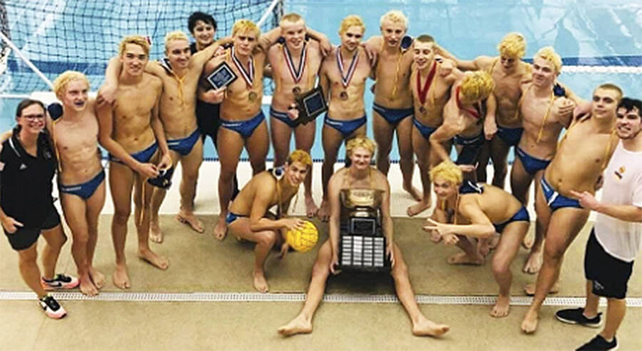 The Bainbridge water polo team gathers around the state championship trophy. Courtesy Photo