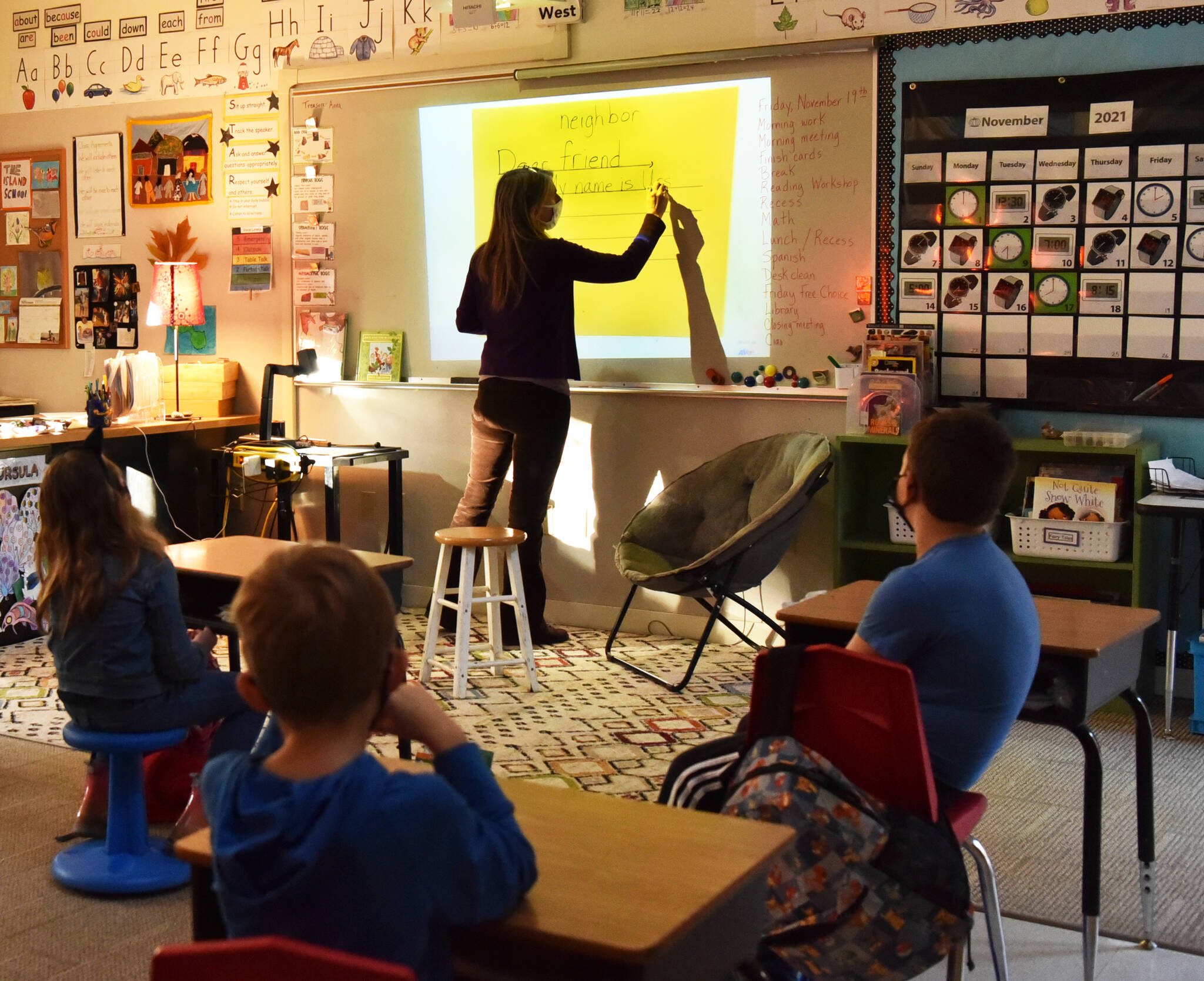 Island School second-graders listen to teacher Ursula Pontieri as she guides them through the steps of writing a card that were included in the Community Thanksgiving Meal deliveries.