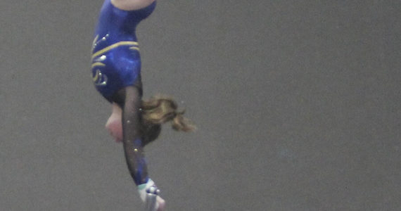 Avery Gray of Bainbridge, who won the all-around, goes vertical on the high bar against North Kitsap. Steve Powell/Bainbridge Review photos