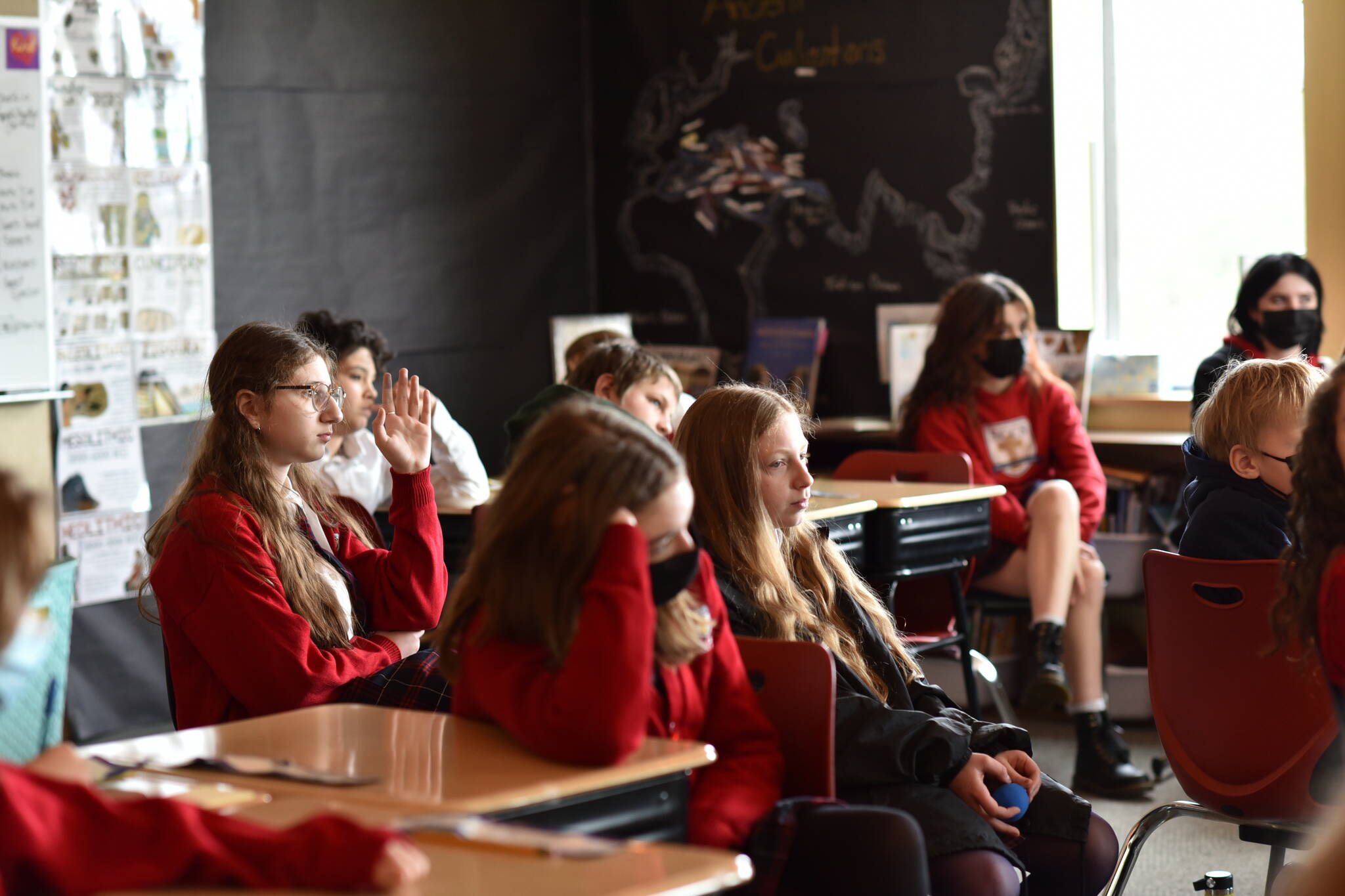 Left: Students in grade levels four through eight listen to a report from Jake Gillanders and ask questions about his trip.