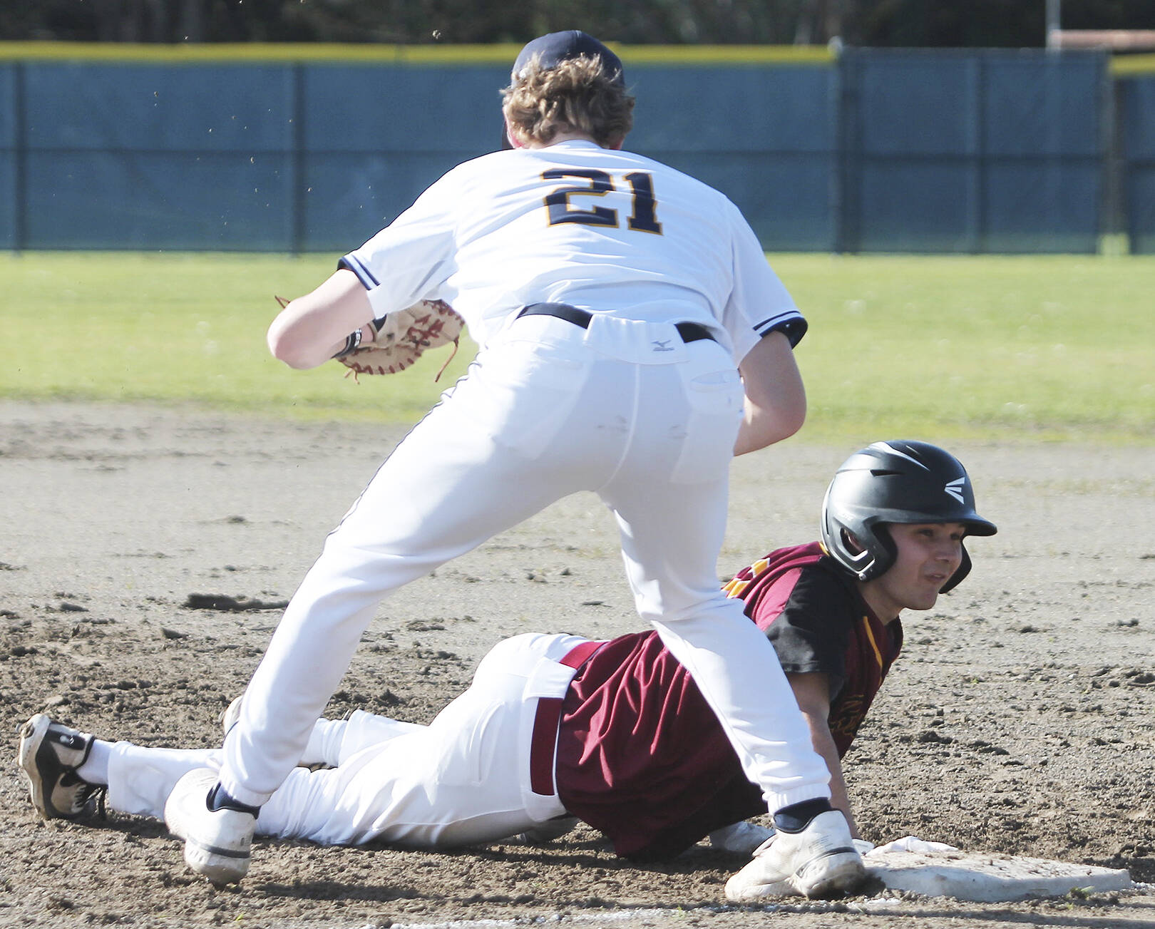 Sophomore first baseman Owen Browning (21) slaps the tag on a Kingston runner diving back to first.