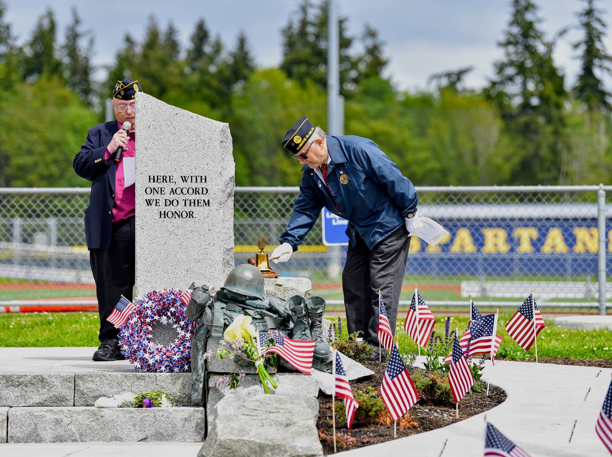 American Legion members Bill Beck reads the names of the fallen as Jim Walkowski, 2nd Vice Commander, rings a bell honoring each veteran.