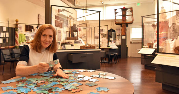 Nancy Treder/Bainbridge Island Review photos
Merilee Mostov putting puzzle pieces together in the “Our Community: Past to Present” exhibit at the Bainbridge Island Historical Museum.