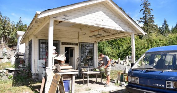 Stone sculptor, Ethan Currier, cleaning up outside his gallery after discovering the theft of his tools. Nancy Treder/Bainbridge Island Review Photos