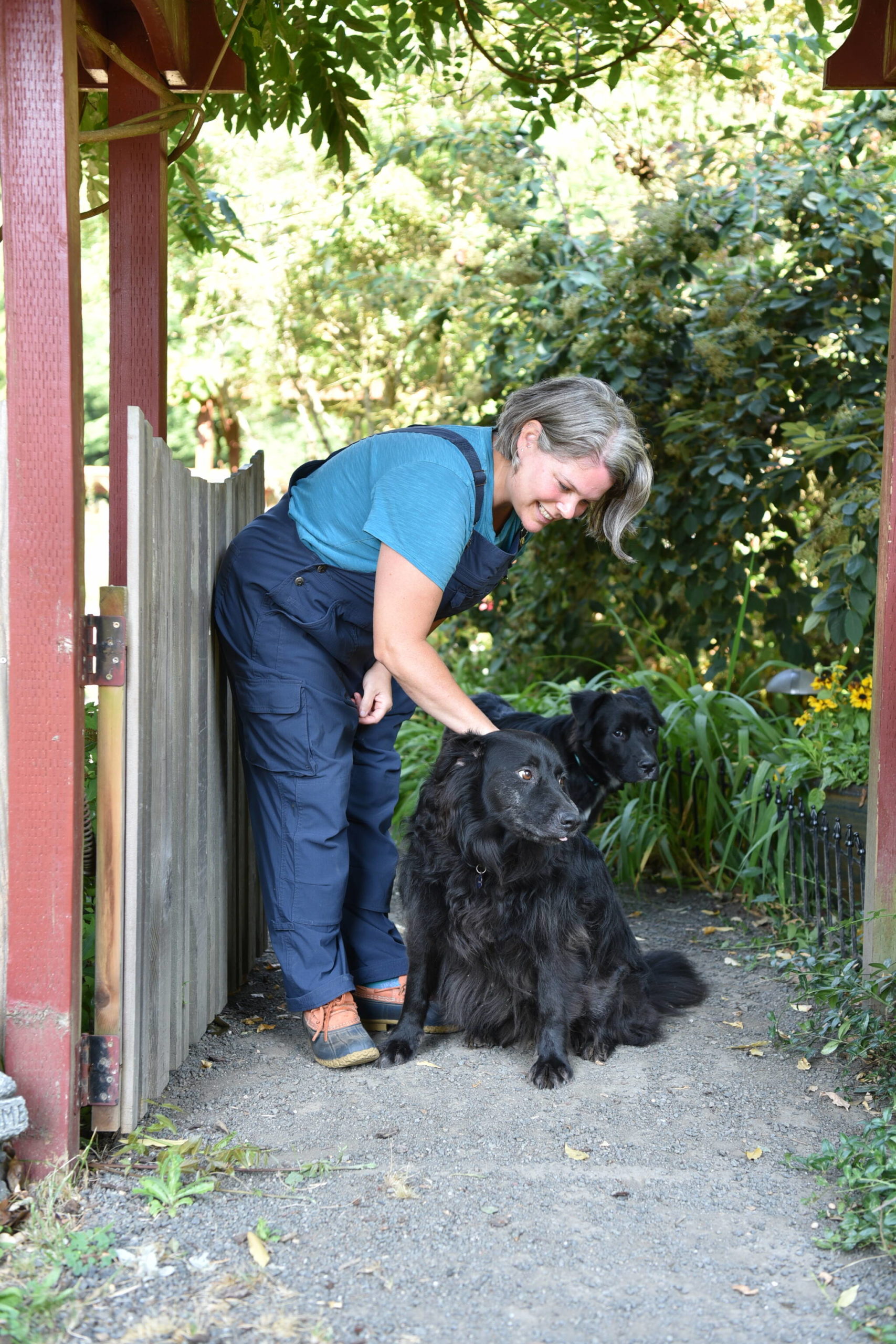 Michele Muffoletto and her dog, Theo, greet visitors at the garden gate on the Wanderers’ Nest Farm on Bainbridge Island.