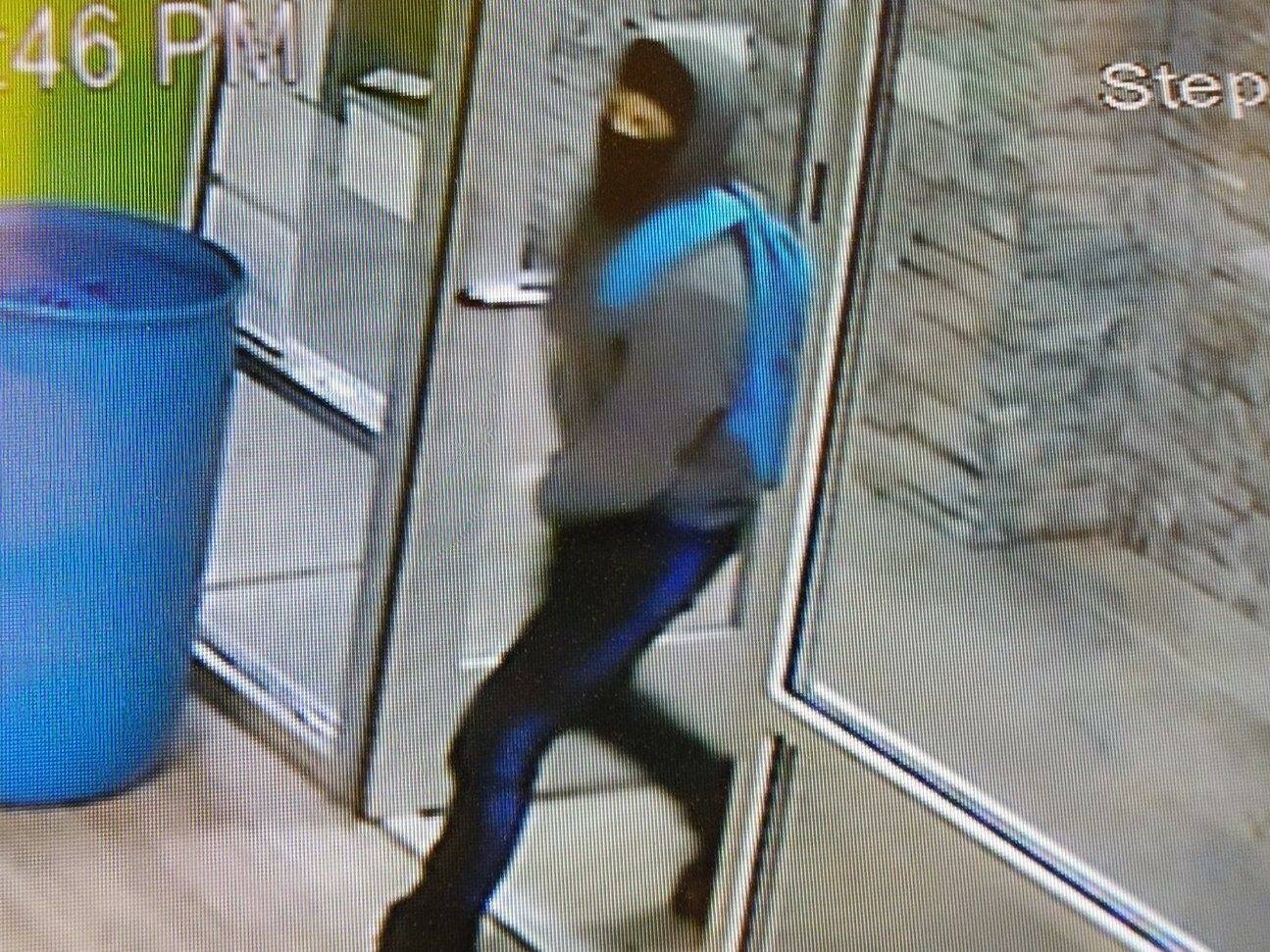 The first of two robbers enter Kitsap Cannabis wearing heavy clothing and a face covering.