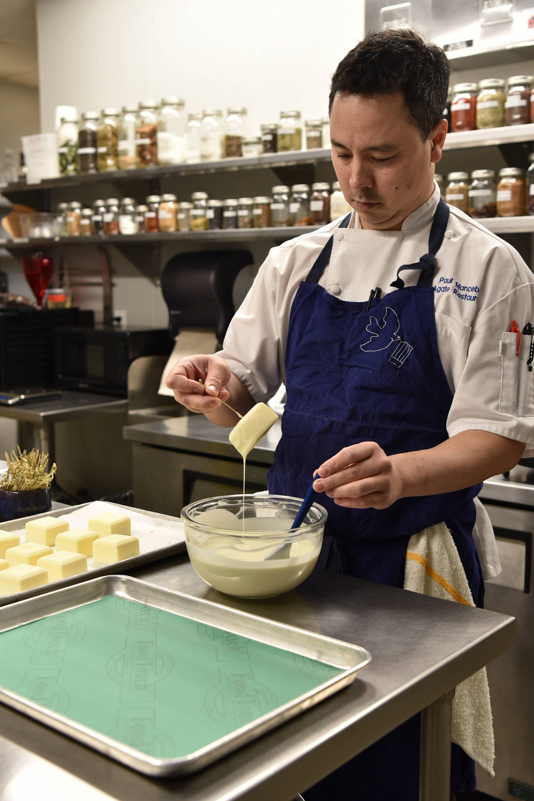 Chef Paul Mancebo prepares chocolate-covered cheesecake desserts in his kitchen at Agate Restaurant.