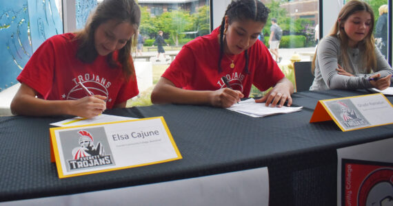 Elsa Cajune, Ghadir Ramadan and Brearley Jayne Curfman sign letters of intent at Bainbridge High School. Nicholas Zeller-Singh/Kitsap News Group Photos