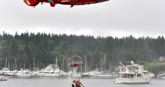 A U.S. Coast Guard diver falls from a rescue litter during a demonstration in Eagle Harbor during the annual Boater's Fair at Waterfront Park June 10. Nancy Treder/Kitsap News Group Photos