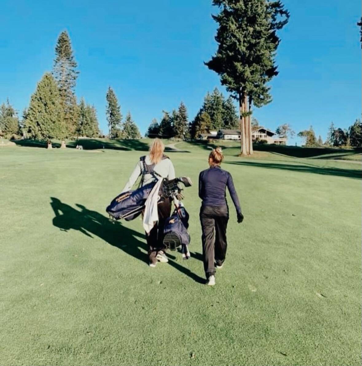 Ian Havill courtesy photo 
Anna Kozlosky carries Kendall’s golf bag while Ian coaches Elise Walter.