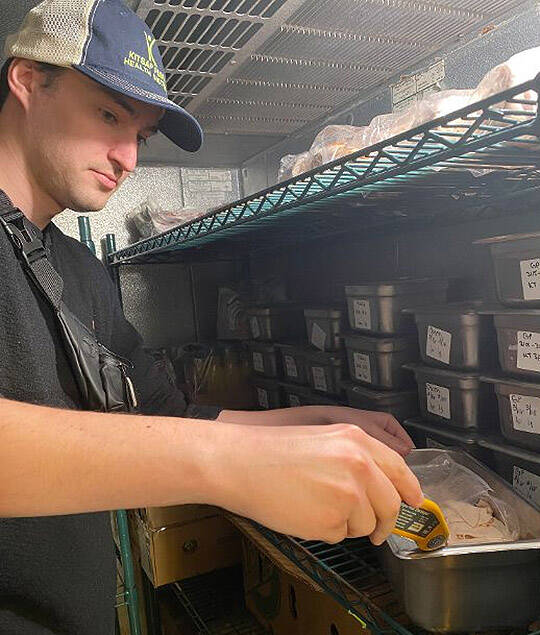 Inspector Nolan Simmons uses a digital thermometer to check the temperature of food to make sure it’s safe.