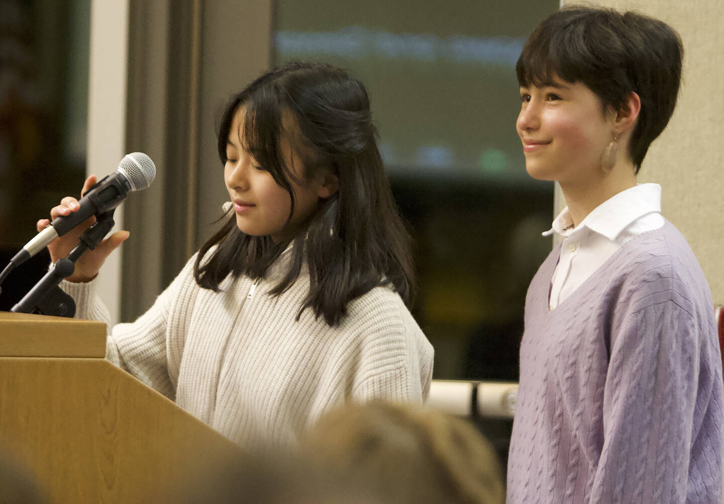 Gina Hasagawa and Simone Newman, Woodward Middle School students, debut their new publication, the Woodward Gazette, at the meeting.