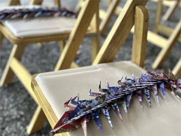 Paper cranes were placed on some of the chairs.