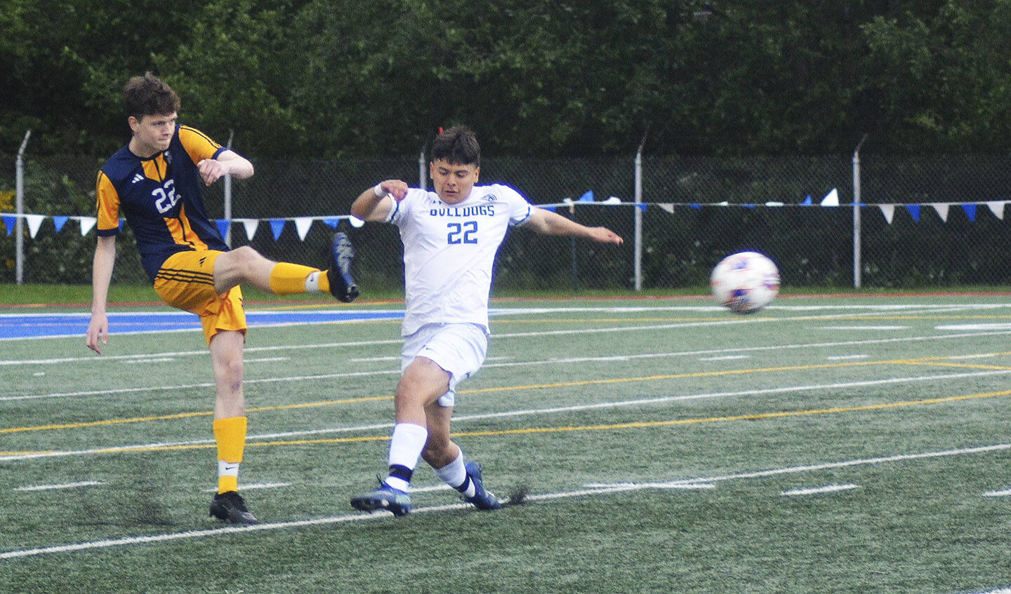 Spartan senior defender Finn McCallum (22) kicks the ball upfield against the Bulldogs.