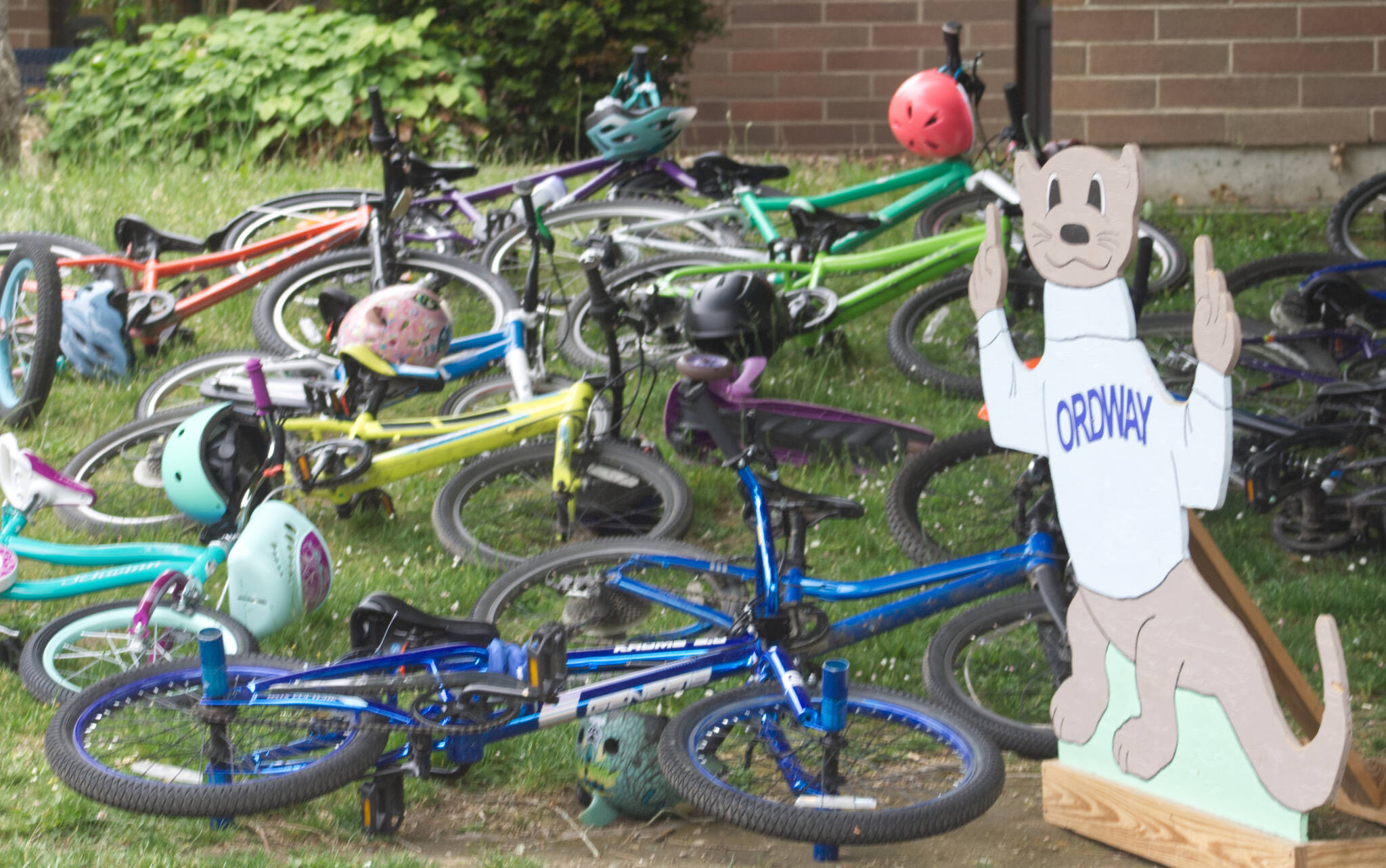 The Ordway otter watches over some bikes stored on the lawn at Ordway Elementary.