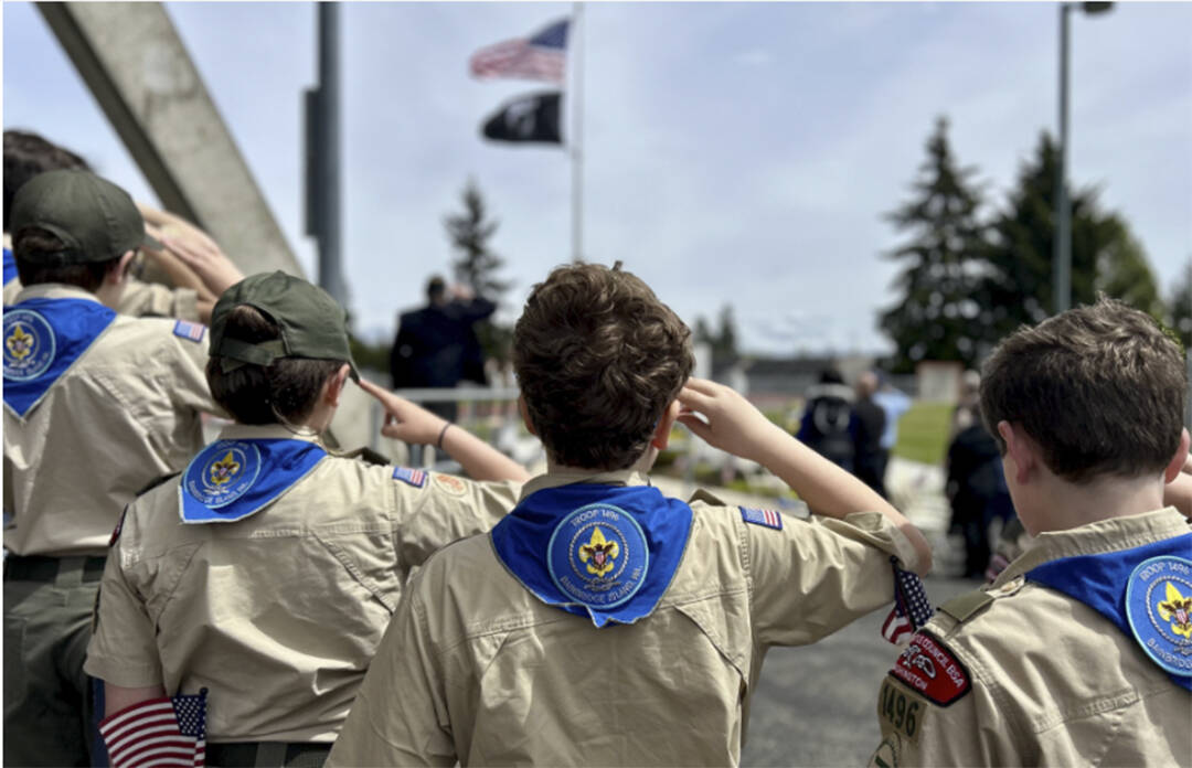 A group of young Scouts salutes the flag during the Memorial Day ceremony.