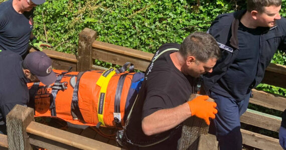 PDF courtesy photo
First responders bring the woman up a flight of stairs after she fell over 20 feet and suffered a head injury.