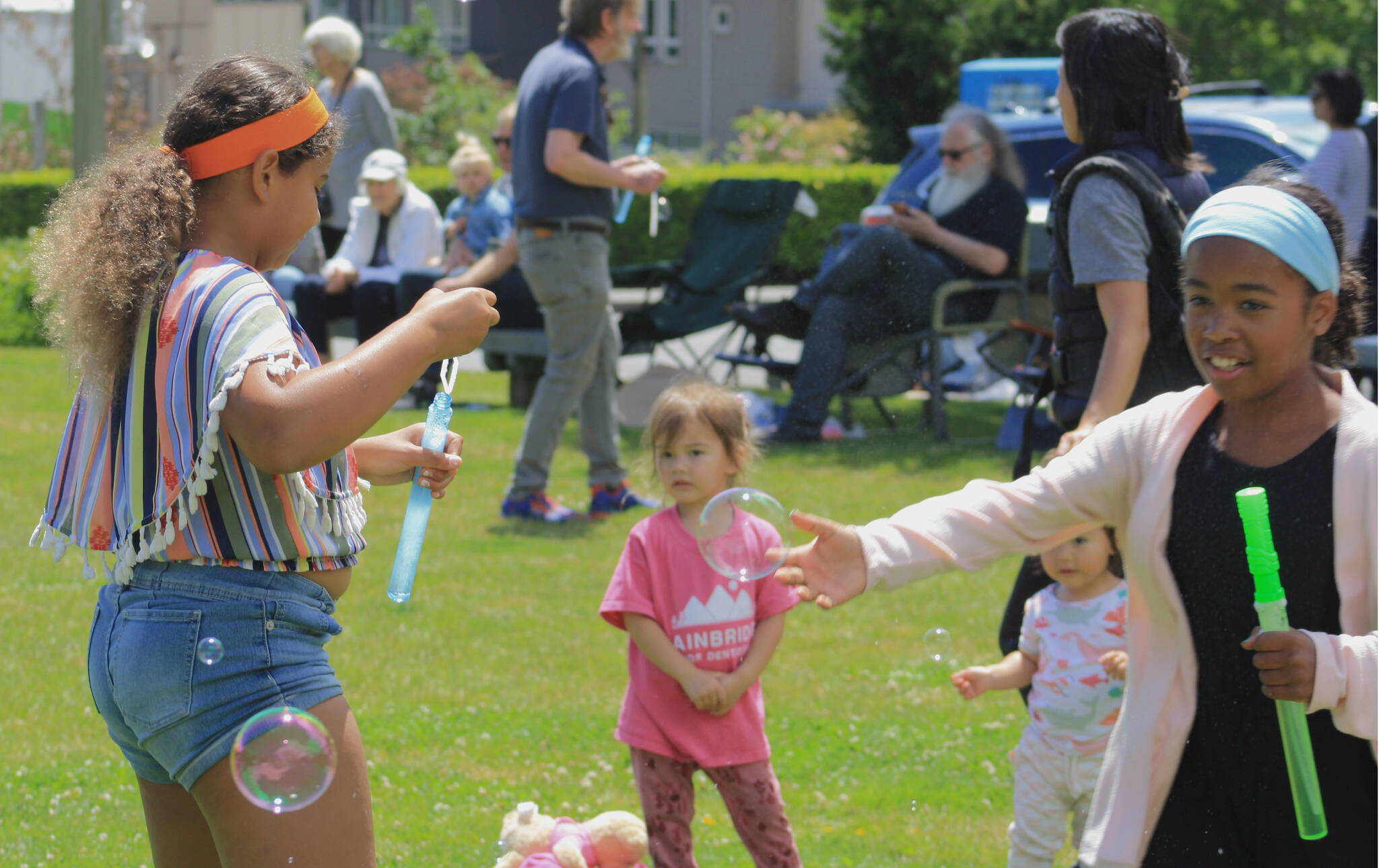 Kids shared bubble wands and chased bubbles around the Winslow Green June 28.