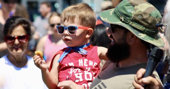 Elisha Meyer/Kitsap News Group photos
Flint Getchell tastes victory with a donut and a first-place prize at the annual Manchester Kids and Pet Parade.