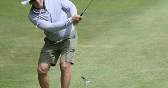 Damon Williams/Kitsap News Group photos
Seahawks legend Steve Largent chips the ball onto the green.