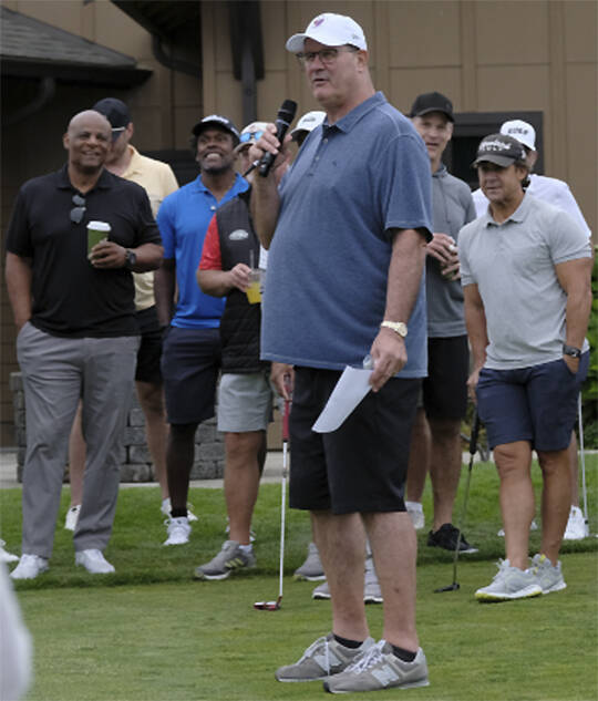 Mike Tice introduces the stars at the tournament, including former Husky and Seahawk great Warren Moon, left.