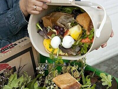 Tim Jewett courtesy photo
A resident adds kitchen food scraps to yard debris in a green bin.