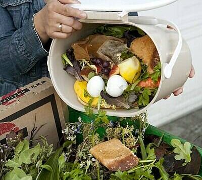 Tim Jewett courtesy photo
A resident adds kitchen food scraps to yard debris in a green bin.