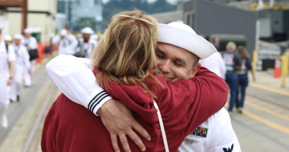 Elisha Meyer/Kitsap News Group photos
Adam Lachman is wrapped in an embrace by family upon his arrival to Bremerton aboard the USS Ronald Reagan.