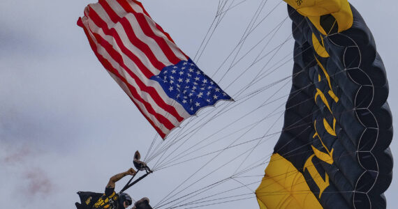 Damon Williams/Kitsap News Group photos
A U.S. flag flown in via parachute kicks off the airshow at the Bremerton Airport Aug. 17.