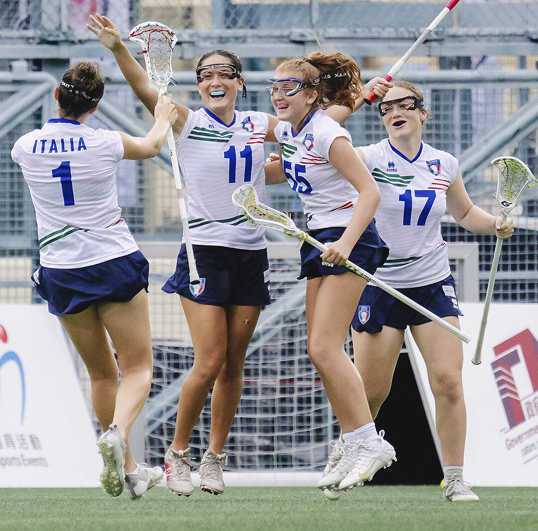 Ainsley James (55) of Bainbridge Island celebrates with her Italian teammates after scoring a goal against Scotland.