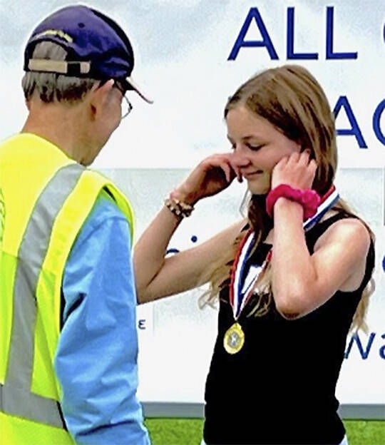 Vivian Gray receives her gold medal for co-winning the girls overall competition.