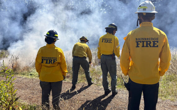 Molly Hetherwick/Kitsap News Group photos
Bainbridge Fire Department personnel monitor a flame.