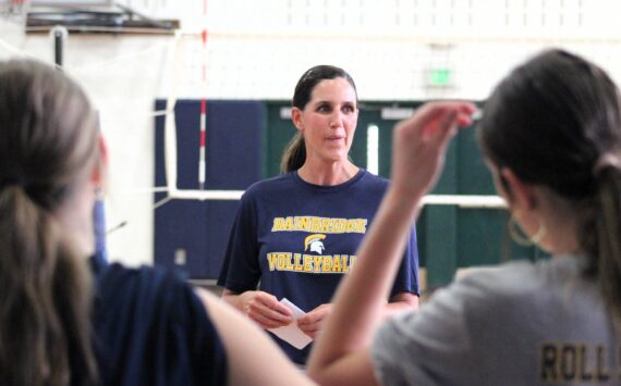 Elisha Meyer/Kitsap News Group photos
Bainbridge High volleyball coach Holly Rohrbacher brings her players together for a talk before practice in the first week of the new fall season.