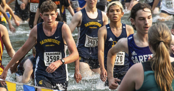 BHS XC courtesy photo
Senior Jack Thompson and Junior Andrew Domansky push through almost waist-high waters in Lake Wilderness at Saturday’s Tahoma Relays. They were on the Bainbridge team that placed 13th.