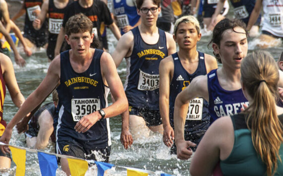 BHS XC courtesy photo
Senior Jack Thompson and Junior Andrew Domansky push through almost waist-high waters in Lake Wilderness at Saturday’s Tahoma Relays. They were on the Bainbridge team that placed 13th.