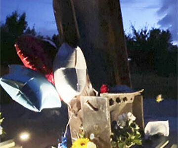 Kitsap 9/11 Facebook courtesy photo
Flowers and notes surround the beams from the Twin Towers in New York that were made into a memorial in Bremerton Sept. 11.