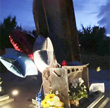 Kitsap 9/11 Facebook courtesy photo
Flowers and notes surround the beams from the Twin Towers in New York that were made into a memorial in Bremerton Sept. 11.