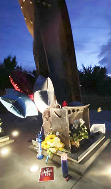 Kitsap 9/11 Facebook courtesy photo
Flowers and notes surround the beams from the Twin Towers in New York that were made into a memorial in Bremerton Sept. 11.