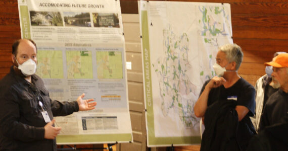 Molly Hetherwick/Kitsap News Group photos
BI senior planner Peter Best gestures to a posterboard titled ‘Accommodating Future Growth’ during a Q&A session with Island Center residents.