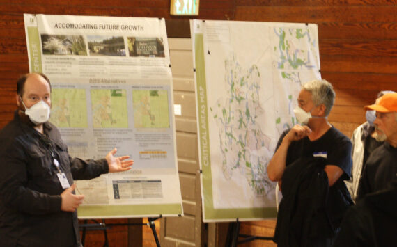 Molly Hetherwick/Kitsap News Group photos
BI senior planner Peter Best gestures to a posterboard titled ‘Accommodating Future Growth’ during a Q&A session with Island Center residents.