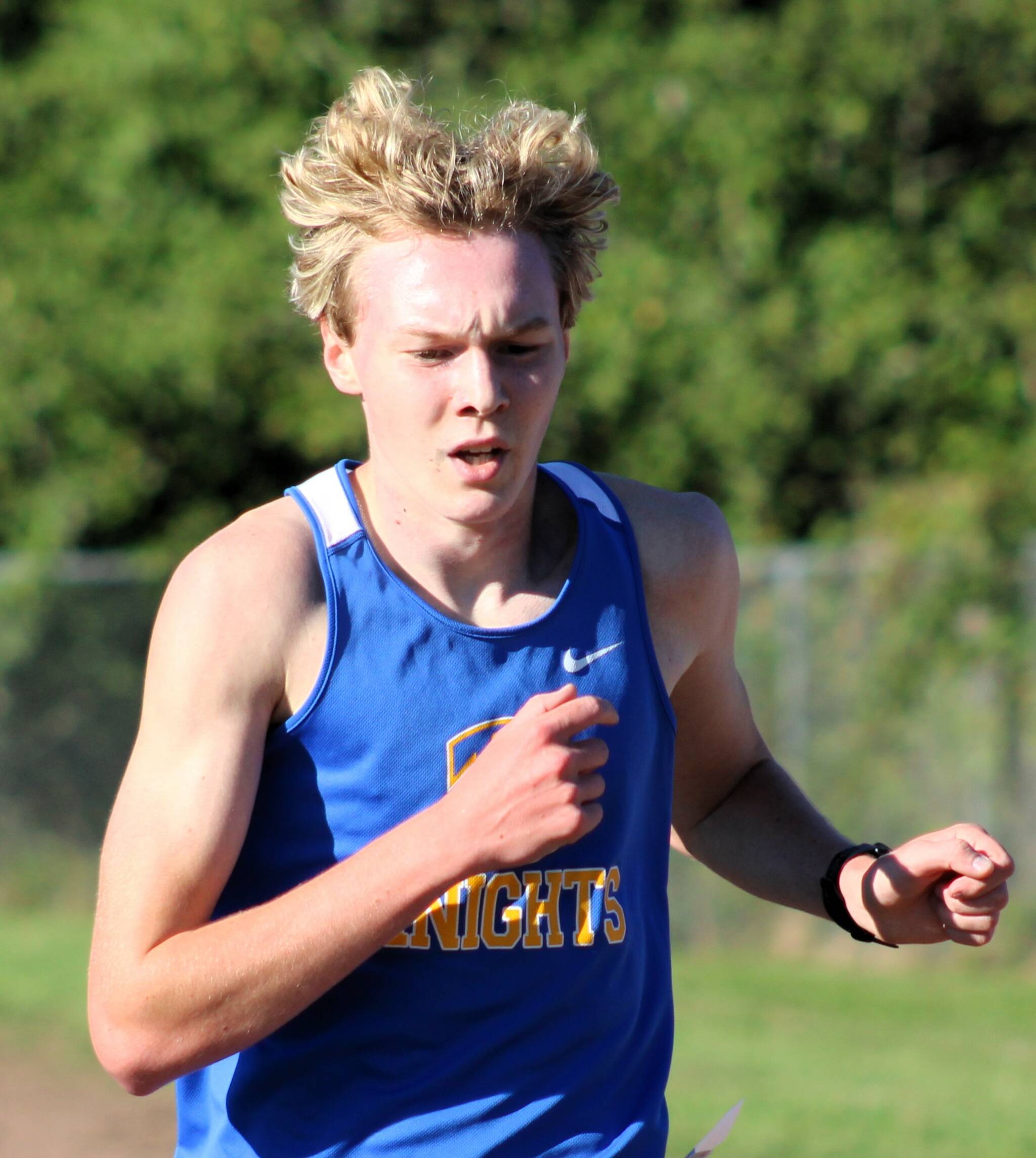 Bremerton senior Dallin Anderson crosses the finish line at the Olympic League opener in Kingston.