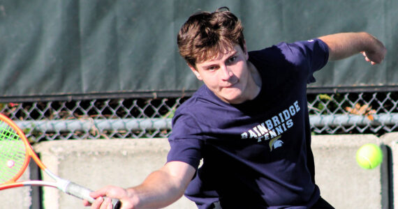 Elisha Meyer/Kitsap News Group photos
Garner Hall reaches out to catch the path of a bouncing tennis ball in a singles match.