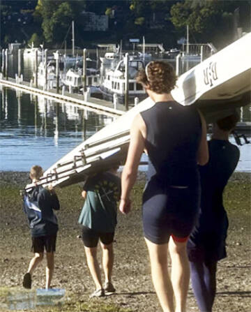 Rowers take their shell down to Eagle Harbor before setting out to more open waters in Puget Sound.