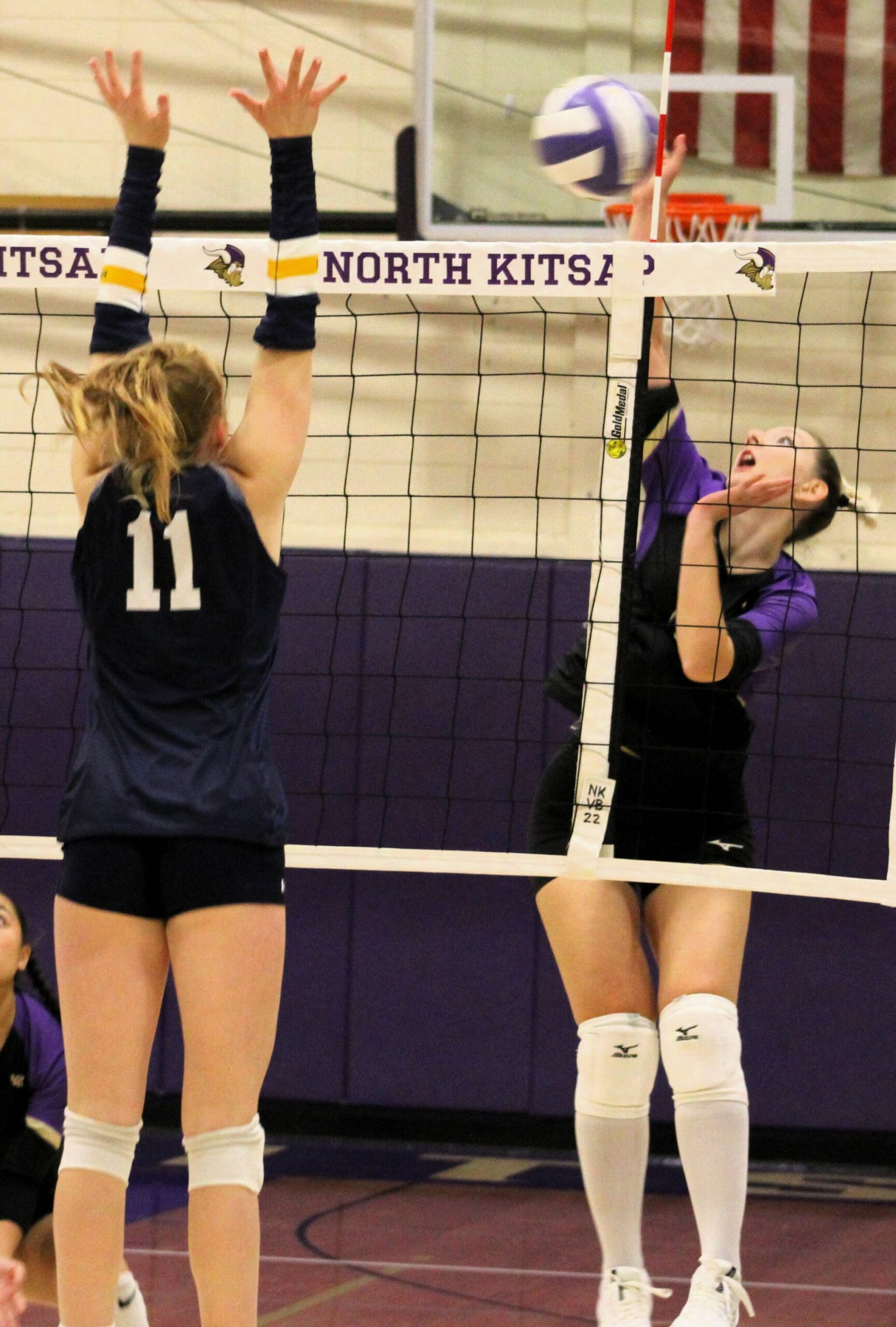 Viking senior Agata Arsi is met at the net one-on-one by Bainbridge junior Rollins Anderson.