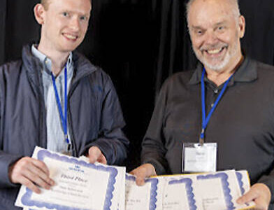 WNPA courtesy photo
Tyler Shuey and Steve Powell pick up the awards won by Bainbridge Island Review staff.